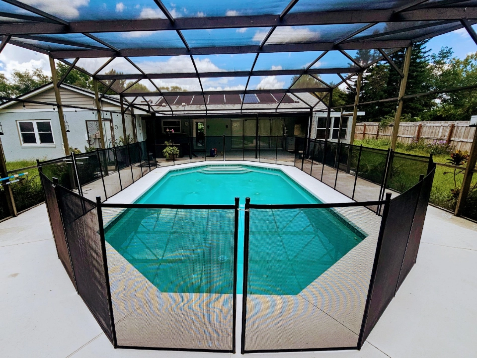 mesh pool fence installed inside a Florida screen enclosure